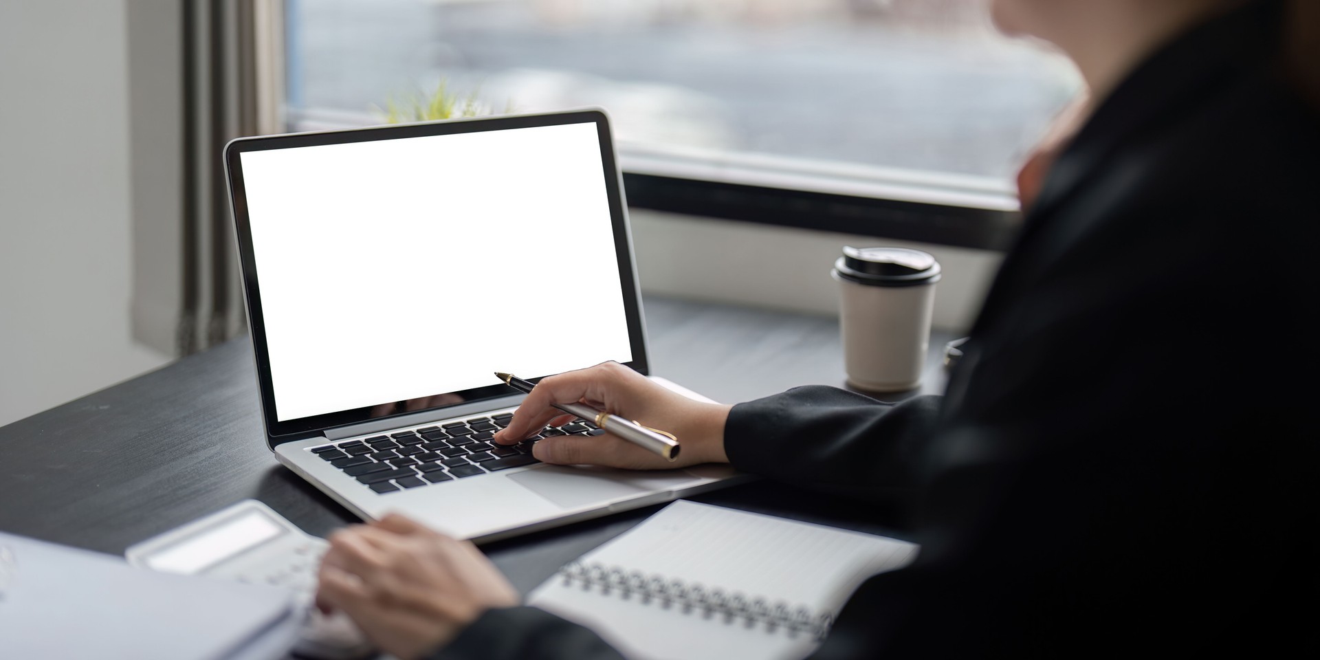 Real Estate Investor with Laptop, checking their dashboard and staying up to date with their rental property, with a coffee