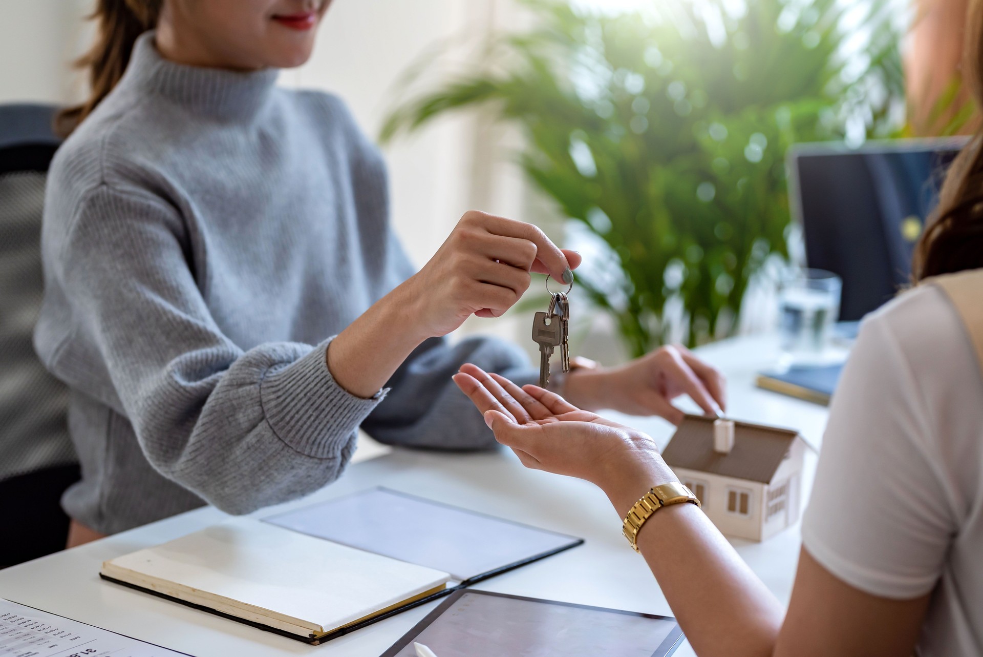 Home and real estate trading business. Real estate agent giving keys to house woman owner.