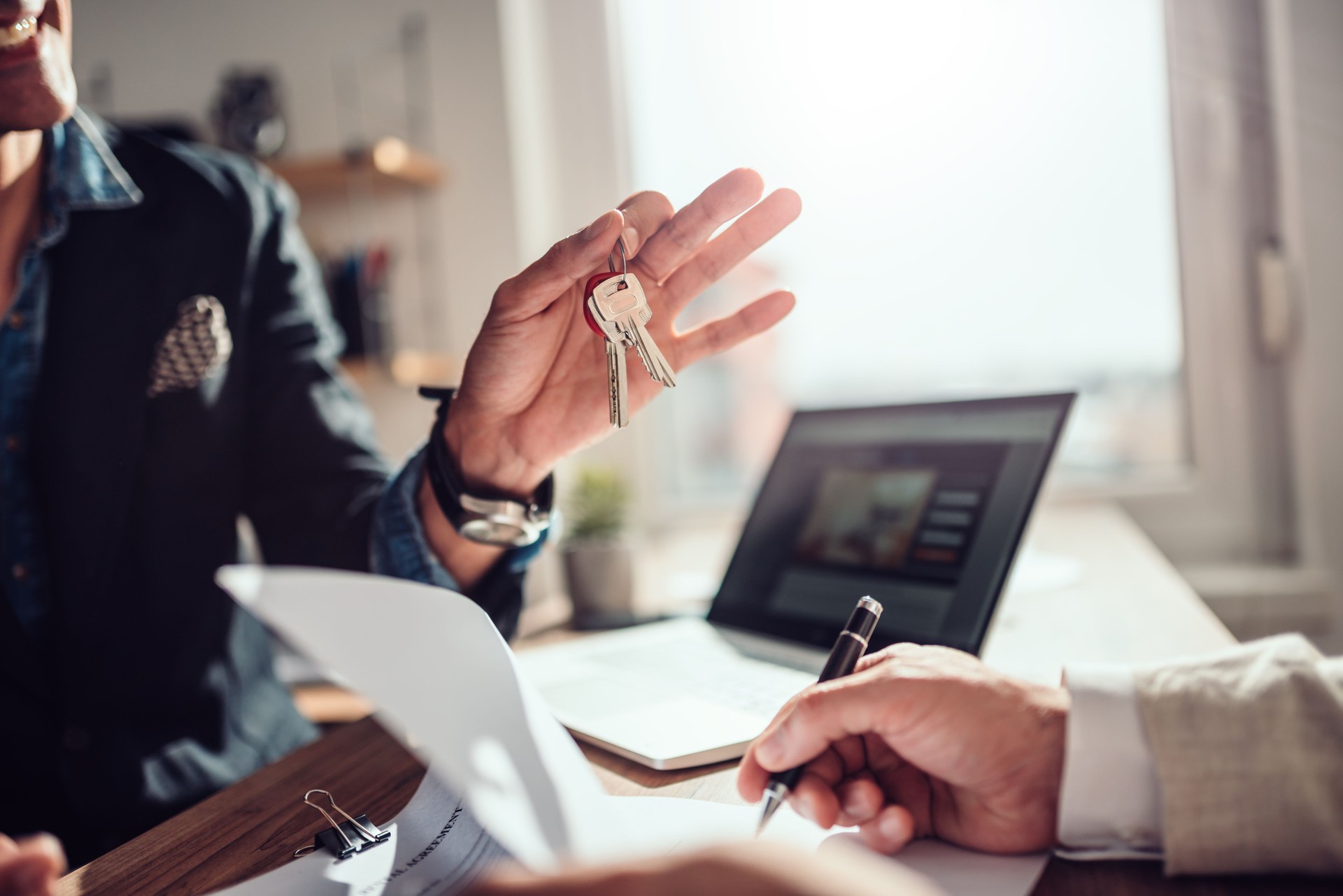 Client signing lease while real estate agent holding keys